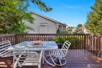 Raised deck sits up with some neighborhood view and stairway to the lower patio and fully fenced backyard.