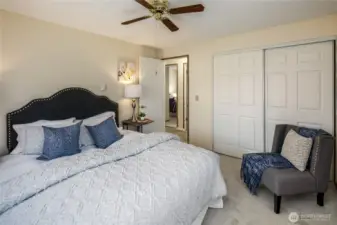 Primary bedroom with ceiling fan, new paint and carpeting!