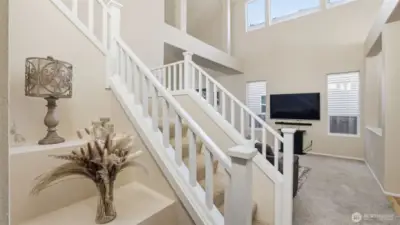 The stunning staircase and high ceilings create a grand yet comfortable everyday living environment.