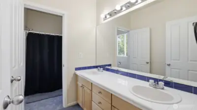 Dual vanity guest bathroom with a private shower and water closet space, ideal for busy mornings.