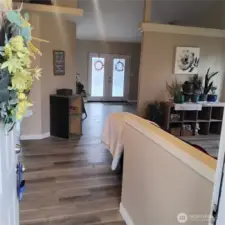Entry into Living Room with view towards Family Room and French Doors to backyard