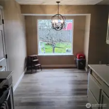 Dining area with new light fixture. Brand new picture window has a view of the Honey Crisp Apple Tree.