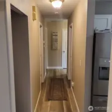 Hallway with brand new waterproof flooring and neutral paint color thru out the home.
