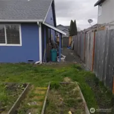 Side of the house has an overhang area for storage.