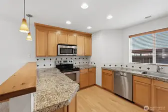Plenty of counter and cabinet space in the kitchen with bar seating.