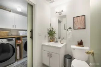 Cute half bath and laundry with storage.