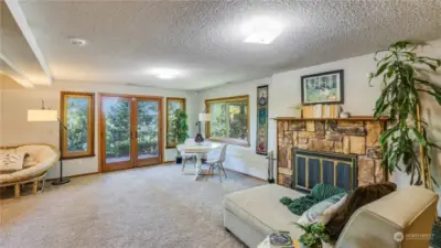 Basement living space with cozy fireplace and easy access to the full length deck.