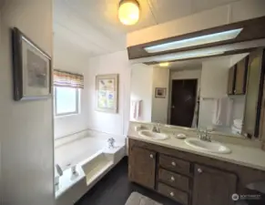 Primary bathroom featuring a soaking tub and shower