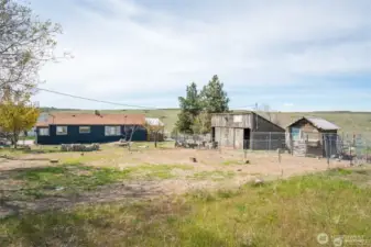 Home, barn, & chicken coop with vast views behind.