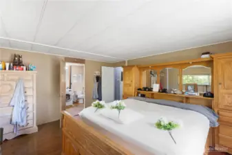 Primary bedroom with the primary bathroom and utility room behind