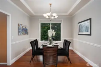 From the large living room, the space opens to a formal dining room.