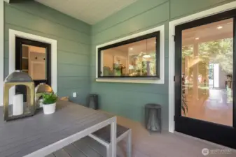 Covered deck with the coolest kitchen passthrough. This space flows directly into the backyard.
