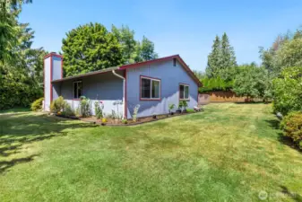 A rare combination of space and seclusion—this sunny backyard stretches wide and deep with a backdrop of mature trees and endless potential.