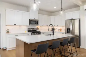 The microwave/hood is built-in and quartz countertops.