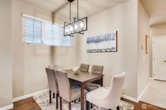Open dining space showcasing proximity to the laundry nook and kitchen layout.