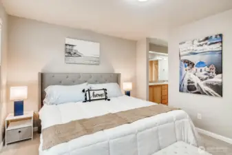 Another angle of the third-floor primary bedroom highlighting the entrance to the ensuite bath.