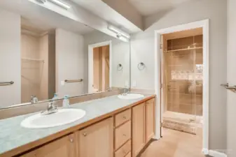 Spacious primary bathroom featuring a double vanity and ample storage.