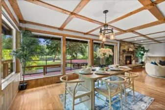 Dining space with stunning lake views, wood-beam accents, and a wall of floor-to-ceiling windows that fills the room with light and visual appeal.