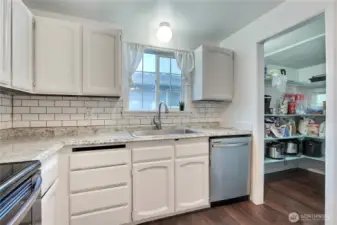 View of the kitchen with nice sized pantry.