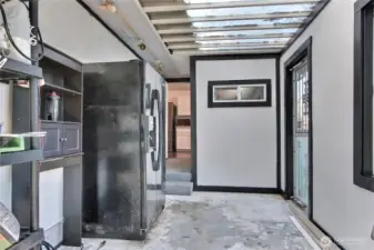 Enclosed patio/sunroom. Fridge, work bench and shelving convey