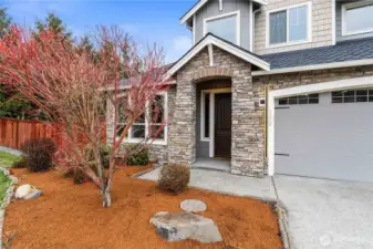 Welcoming front porch featuring stone accents