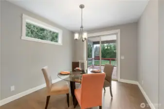 Eating nook in kitchen leads to covered outdoor deck