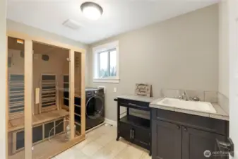 One of 2 laundry rooms.  This one is upstairs and features a sauna and a washer/dryer combination