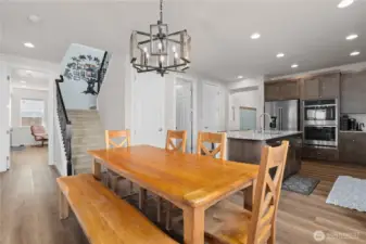 Upstairs leads to spacious family room, three bedrooms and utility room. Open door on the left leads to ADU.