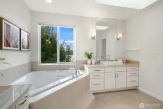 The en-suite bath has double sinks, soaking tub, separate shower, and private water closet