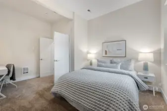 A large additional bedroom downstairs with French doors and tall ceilings is ideal for guests or a home office