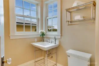 Main floor 1/2 bath is located discretly off the kitchen and also features a view!