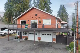 Ample amount of parking, garage space, RV hook-ups on the left, small boat/trailer storage on the right (Under the deck).