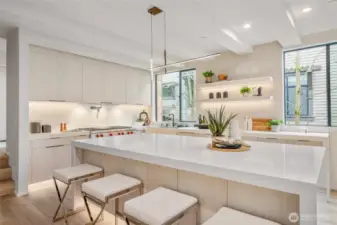 The spacious island, accommodating four stools and additional storage below, is perfect for both dining and organization.
