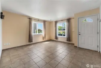 Windows funnel in tons of natural through the living room just located off the entrance of the home!