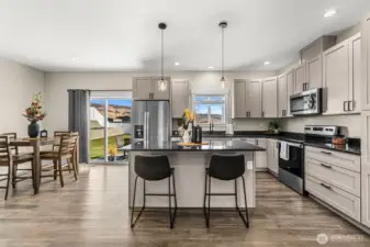 Kitchen eating area and dinning room divided with open space and sliding door to the backyard