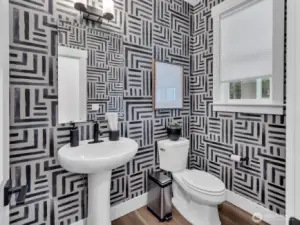 Powder room on main level for guests.  Photo is of model. Elements in home can vary.