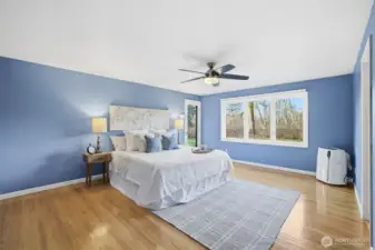 Spacious primary bedroom featuring private backyard access.