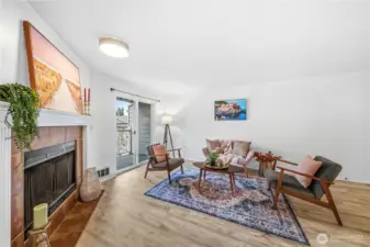 Lovely wood burning fireplace in the open living room.