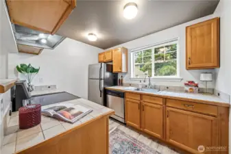 Lovely natural wood cabinetry with new range installed in 2025.
