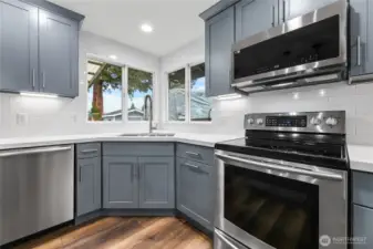 Updated Kitchen Cabinets, Tile Back Splash Extending up Wall to Ceiling.
