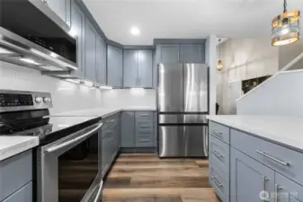 Refrigerator, Under Cabinet Lighting, and Quartz Countertops