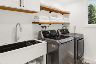 Generous laundry room with build-in-utility sink adds practicality and easy to daily living!
