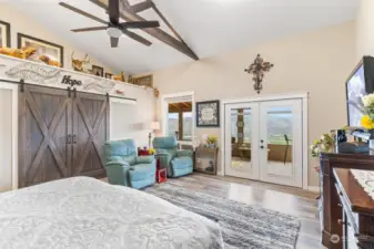 Primary Bedroom. Wow! French doors lead to the enclosed patio, barn doors to a luxurious walk-in closet.