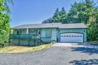 Front of the house from street.  Additional parking to the right of the garage.
