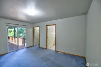 PPrimary bedroom looking toward back deck.  Primary bath and walk-in closet are to the right.