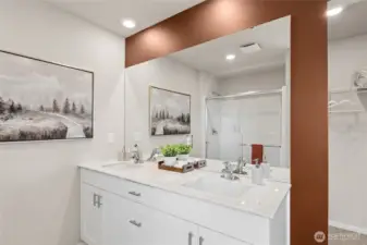 Double vanity in the primary bathroom. Actual home is under construction and finishes, colors, and materials may vary. See site agent for details.