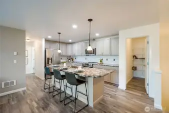 The kitchen is spacious and open to the living room with an oversized island that has a huge eating bar. There is a spacious pantry, as well.