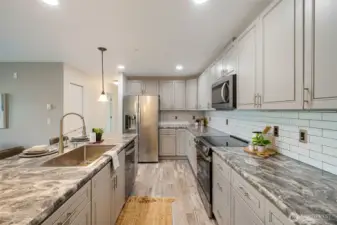 There is an abundance of counter and cabinet storage in the kitchen.