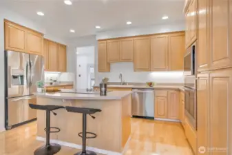 Kitchen features maple cabinets, island cook center, Corian counters, new high-end SS appliances.