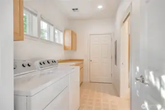 Walk-in laundry with built-in cabinets and sink